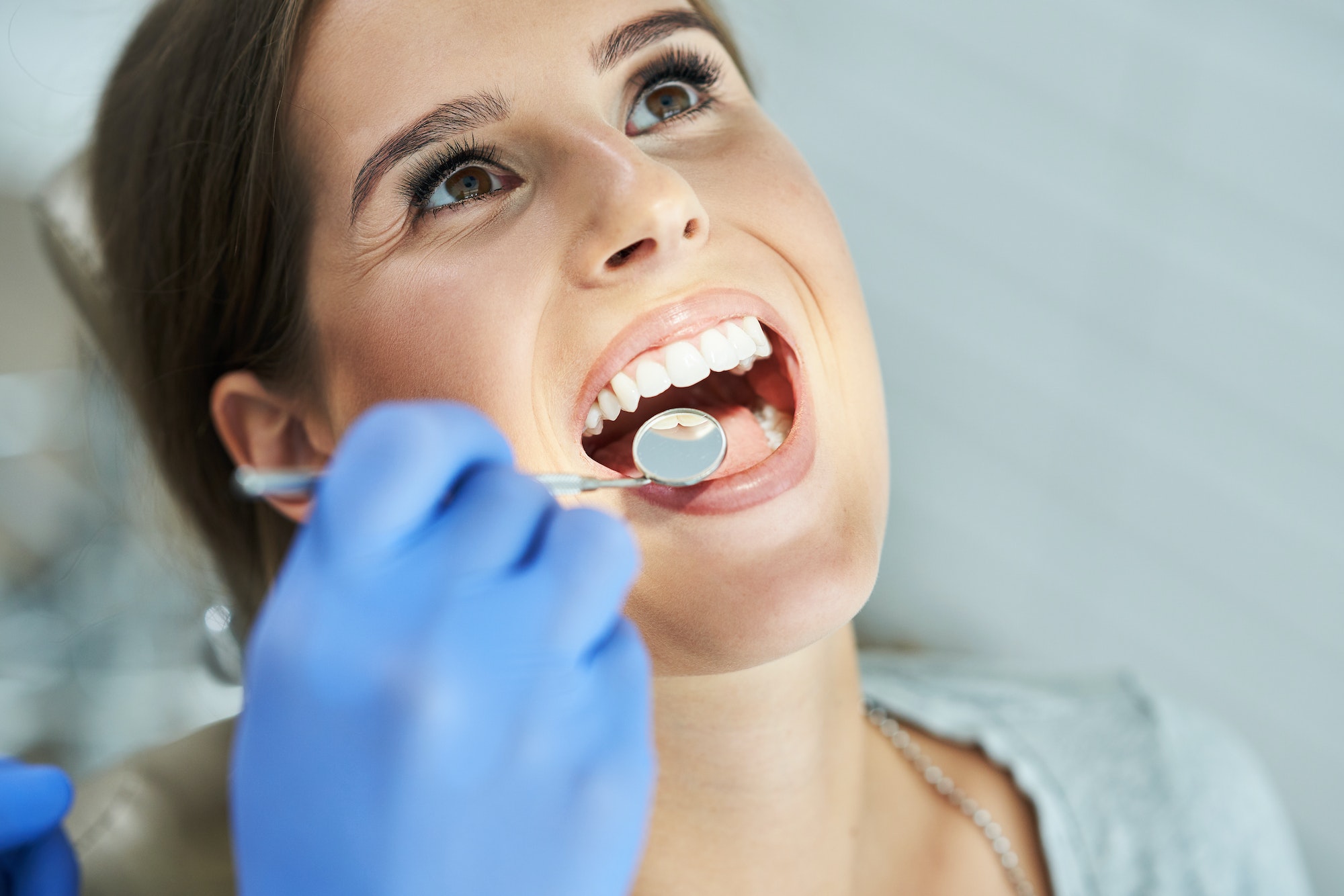 Male dentist and woman in dentist office